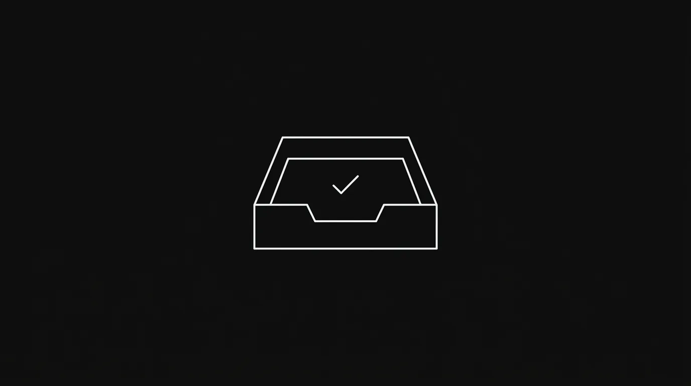 A clean, empty inbox on a laptop screen sitting on a minimal desk — representing the end-of-day inbox zero state